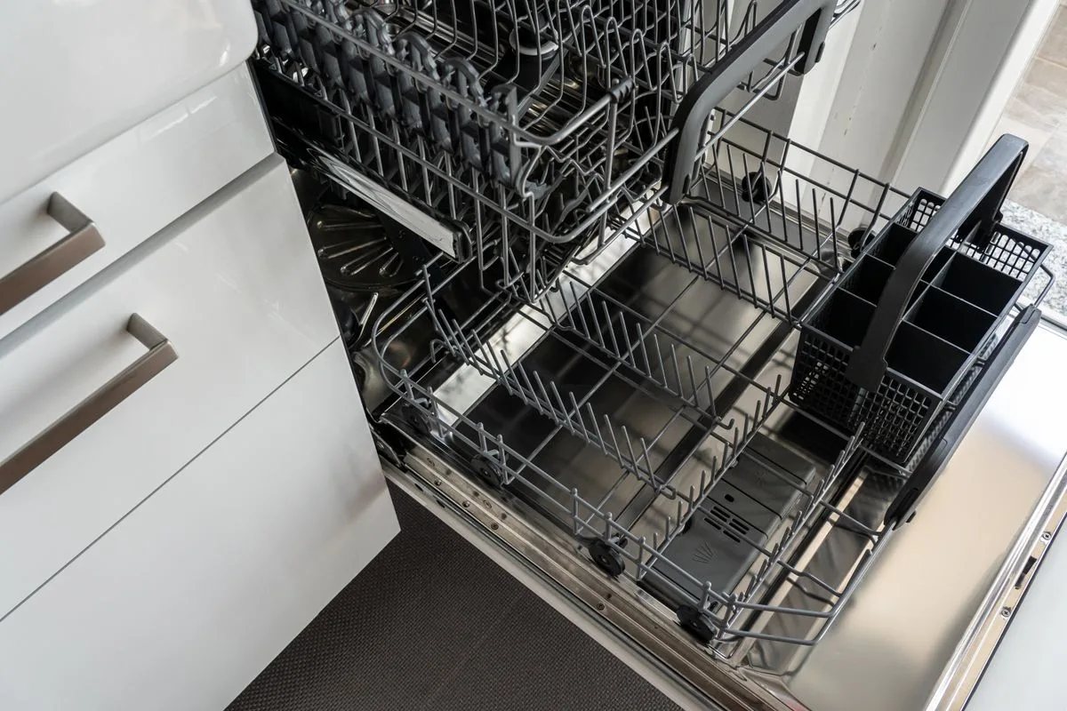 Open dishwasher with extended racks in a modern kitchen