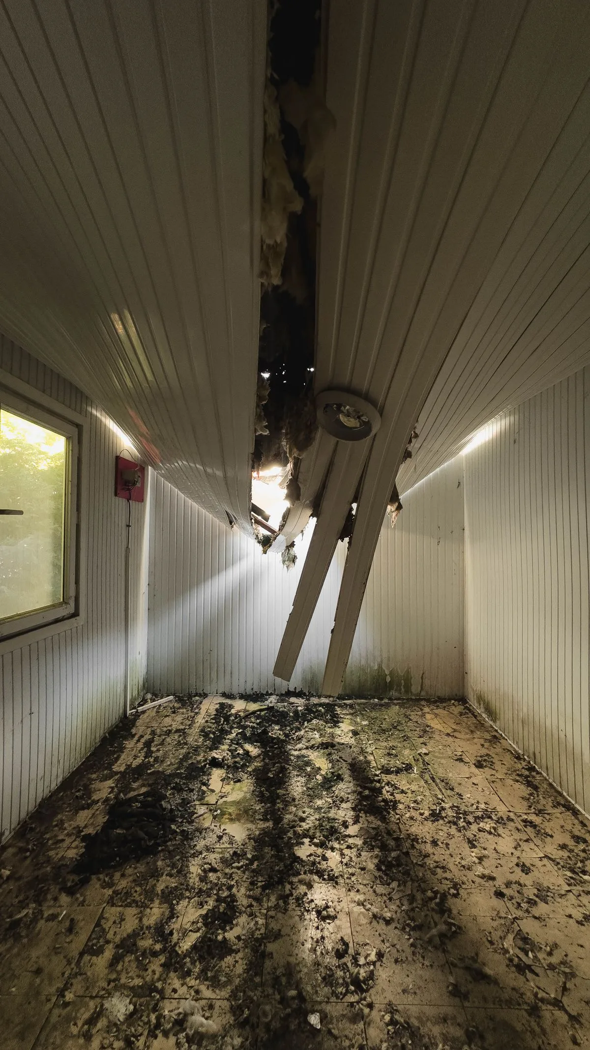 Collapsed ceiling and waterlogged floor after an attic pipe burst