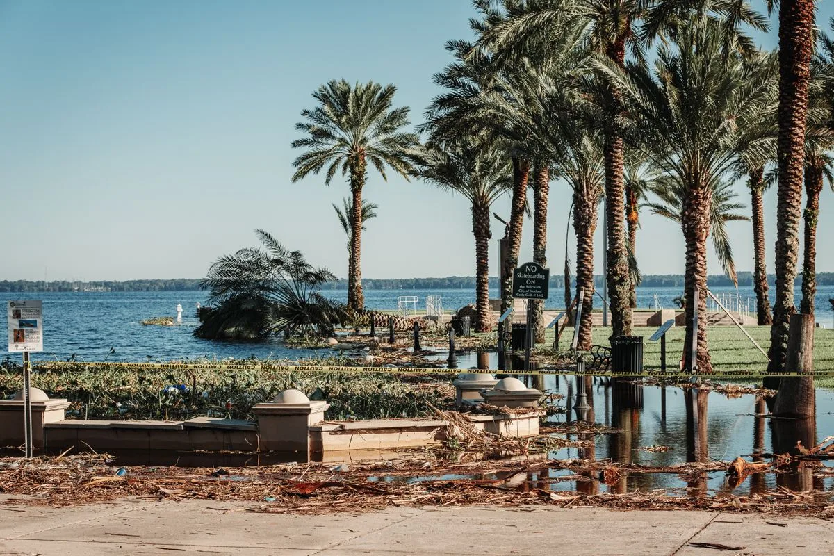 Flooded waterfront park littered with storm debris