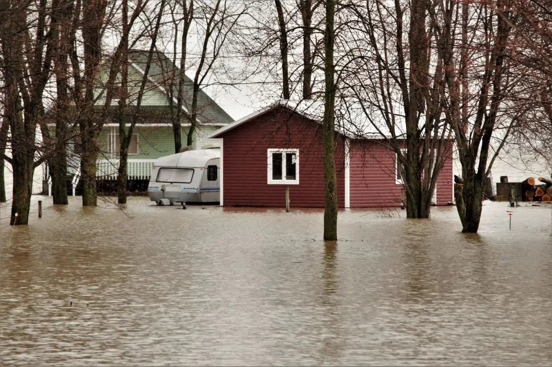 Floodwater surrounding homes and a caravan after heavy rain