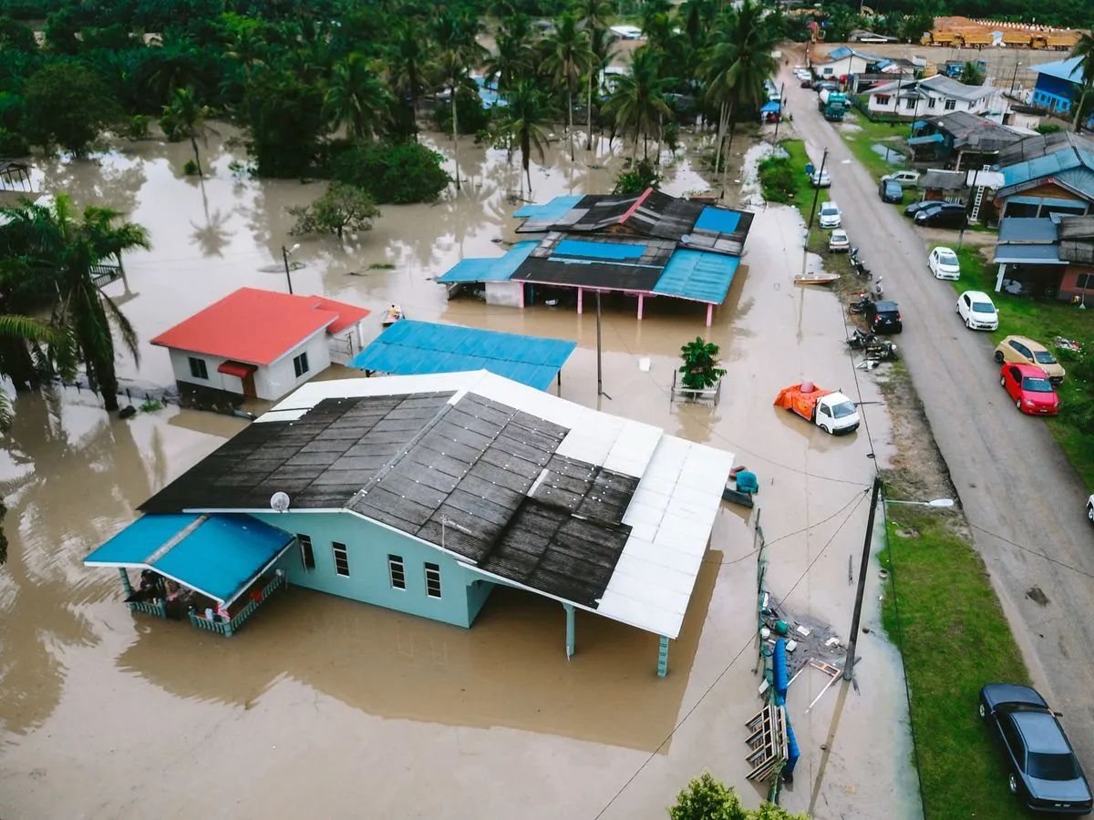 Aerial view of a flooded neighborhood with homes surrounded by floodwater