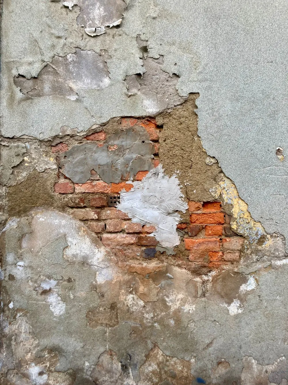 Water-damaged interior wall with peeling paint and staining after a leak